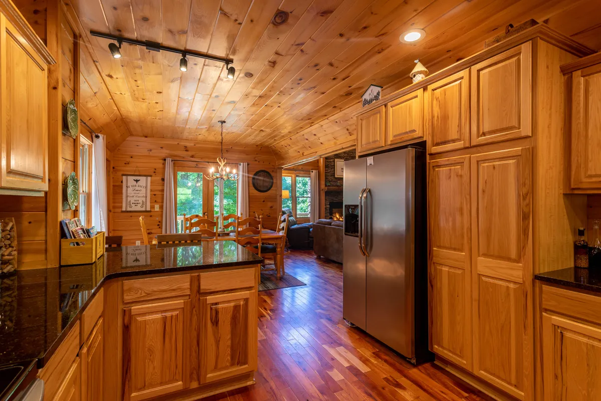 A cozy kitchen with a central island, stainless steel appliances, ample counter space, and a dining area with large windows that let in abundant natural light.